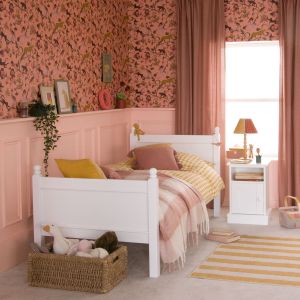 white single traditional child's bed in panelled room with exotic wallpaper
